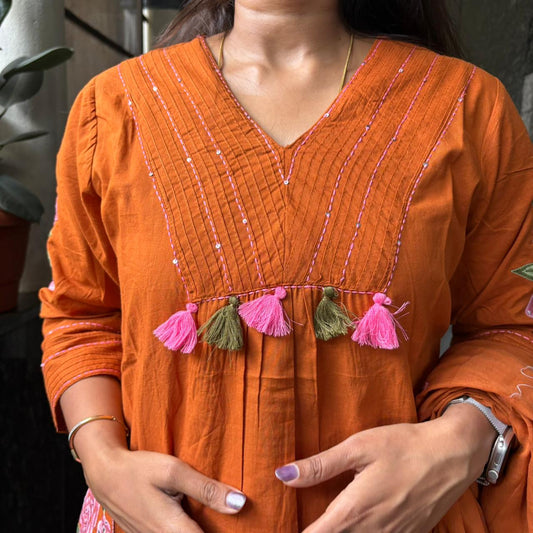 Model holding dupatta in orange kurta set