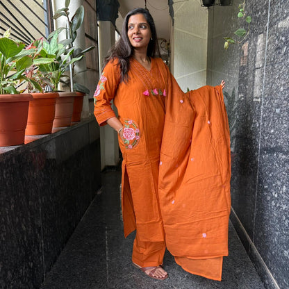 Model wearing orange kurta set with dupatta spread out